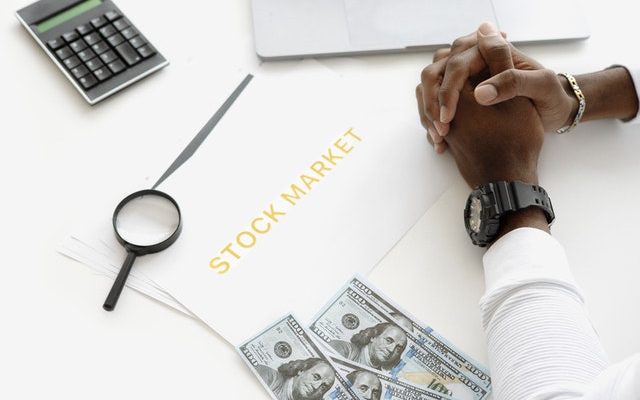 black person sitting to consider the stock market option to make money, perhaps considering using limit orders