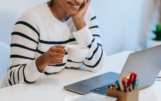 woman smiling while taking a look at her finances