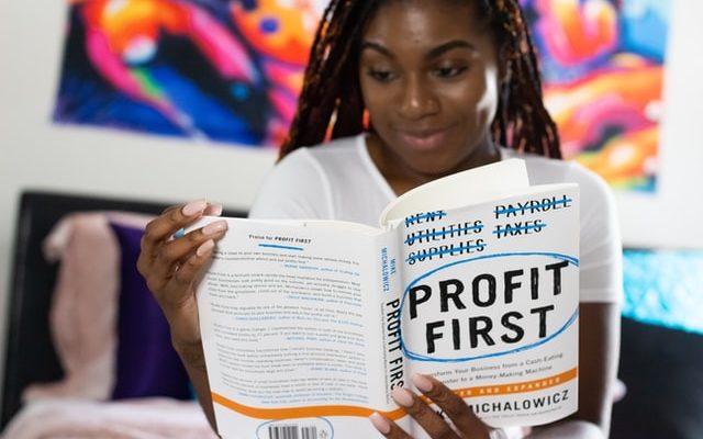 Woman reading a book on financial literacy
