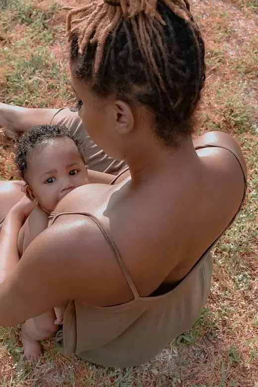 black mother breast feeding baby infant